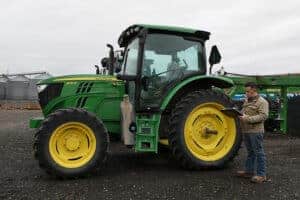 Garrett Schwartz ASA CEA inspecting farm tractor for equipment appraisal