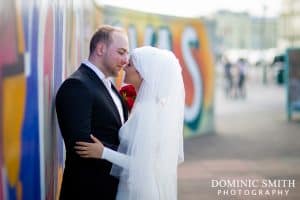 Bridal photo taken on Brighton Seafront with the graffiti in the background