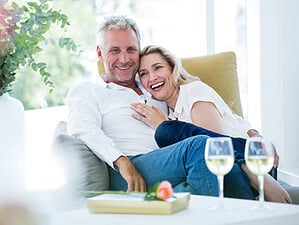 Happy couple cuddling while he secretly wonders if he wants to get married again.