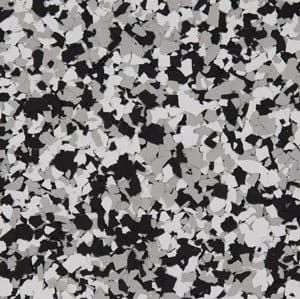 Decorative epoxy garage floor with black, white, and gray flake finish, showcasing durable and stylish concrete coating options.