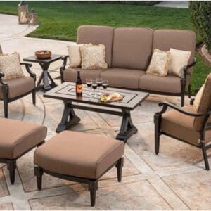 Elegant outdoor patio set with cushioned seating and a glass-top table.