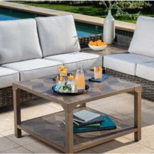 Modern outdoor patio set with drinks and snacks on a bright day.