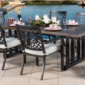 Outdoor dining table set with six chairs by the water.