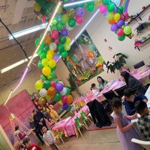 Colorful birthday party setup with balloons and decorations.