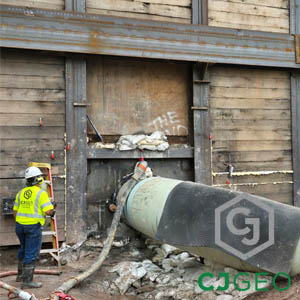 Remote annular grouting project by CJGeo, with a worker standing next to a large pipe.