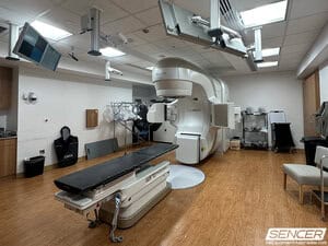 Varian TrueBeam linear accelerator and treatment couch in a radiation oncology suite, equipment valued in a hospital equipment appraisal.