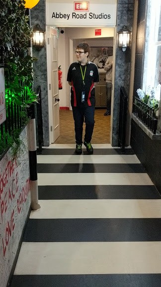 A person standing in front of Abbey Road Studios