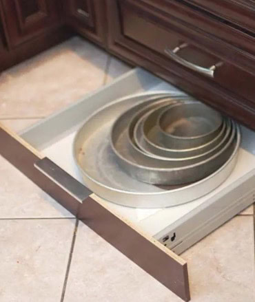 Organize baking pans in a toe-kick drawer.