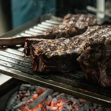Tomahawk de bœuf cuit à la braise au restaurant Les Tontons à Val d’Isère