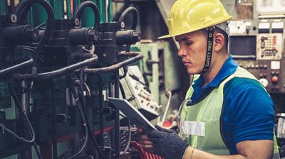 Maintenance technician performing breakdown maintenance on industrial equipment