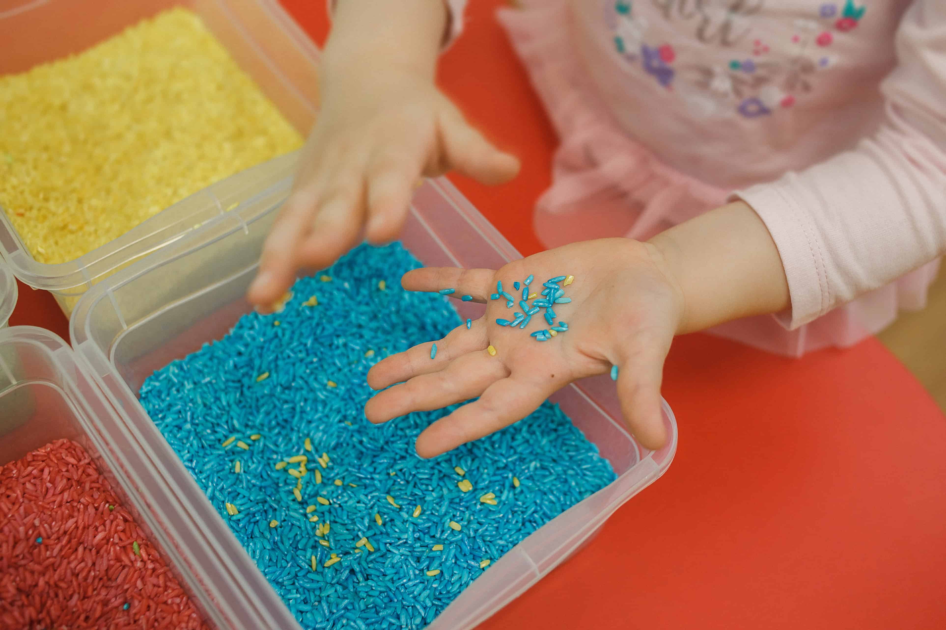 child playing in a sensory bin