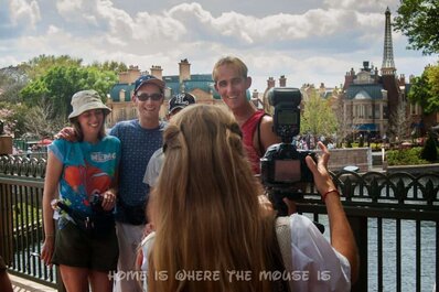 Disney's PhotoPass Photographer gets a group shot in Epcot Disney's PhotoPass Photographer gets a group shot in Epcot