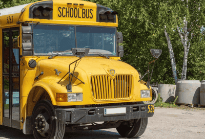School bus parked outside a school, part of district fleet maintenance