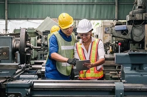 Two workers checking asset performance management