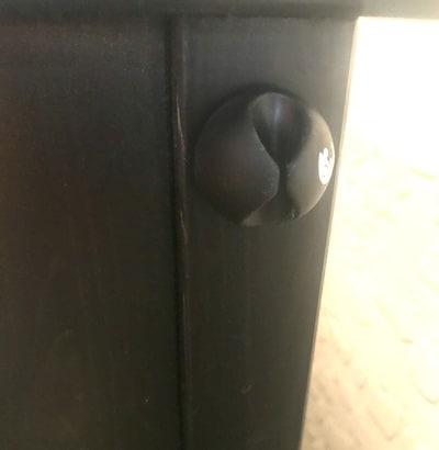 Cable clip attached to the side of a nightstand