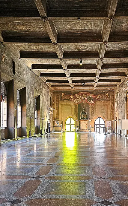 Ornate interior of Sala Farnese inside Palazzo d’Accursio in Bologna, with Renaissance ceiling and grand statue—ideal for architectural and cultural photography in Bologna.