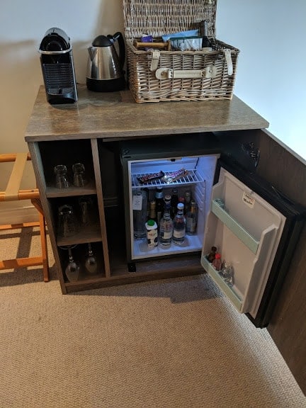 The mini bar in the hotel room and a basket of goodies