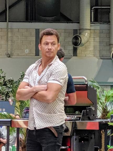 Joe Swash with his arms folded wearing a shirt and jeans at This Morning Live