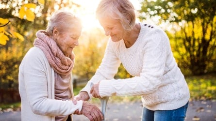 Elderly daughter helping her mother.