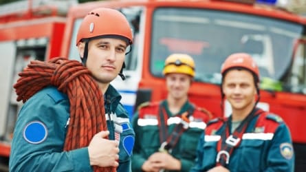 Three firefighters in full gear facing the camera.