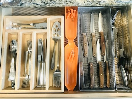 A kitchen drawer with cutlery in drawer organizers