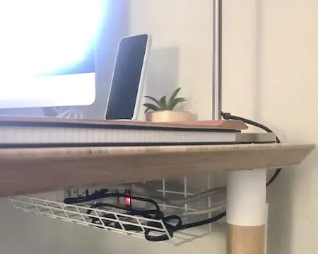 Desk with cable storage tray mounted underneath