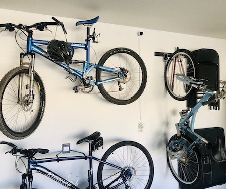 Bikes mounted on wall hooks