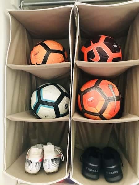 Organize a teen's bedroom: athletic equipment on hanging shelves