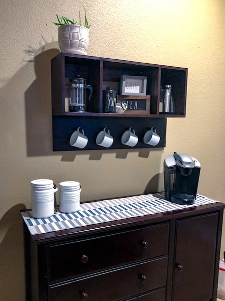 Coffee station with mounted shelves and buffet cabinet