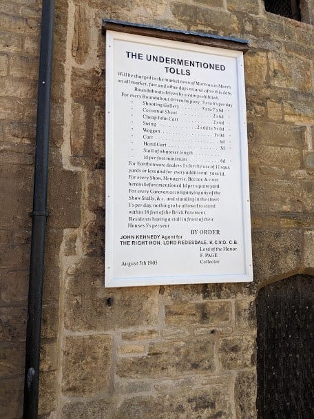 Toll sign on brick wall