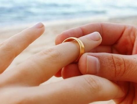 A couple hands exchanging rings. Wedding dinner cruise Charleston SC