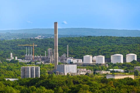 Industrial refinery and facility surrounded by greenery