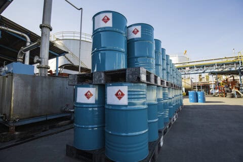 Chemical drums with hazard labels at an industrial facility