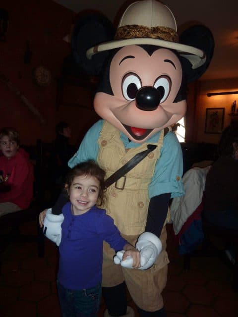 Bella poses with Mickey Mouse in his khaki outfit and safari hat at Tusker House Restaurant