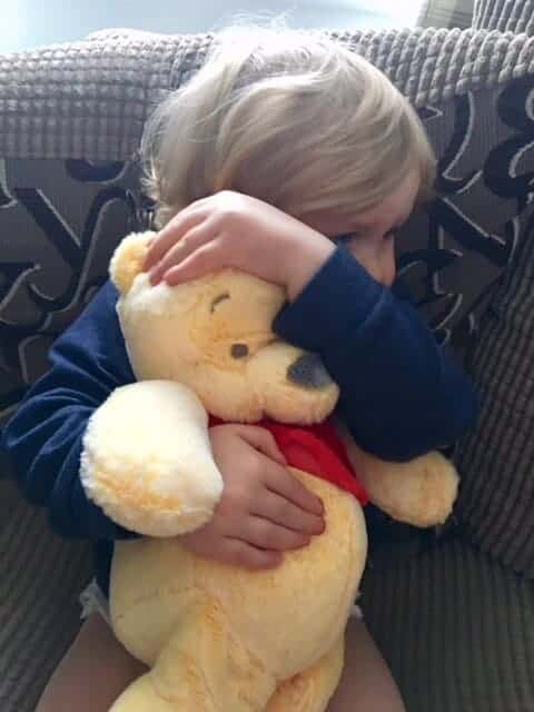 Baby girl with her Winnie the Pooh Posh Paws teddy bear