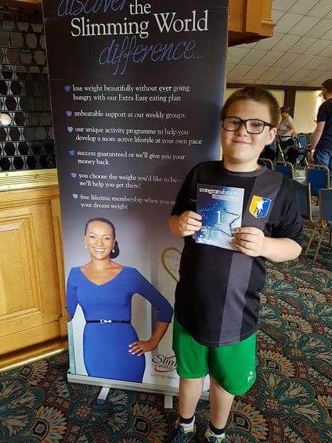 Ben standing proudly with his one stone certificate