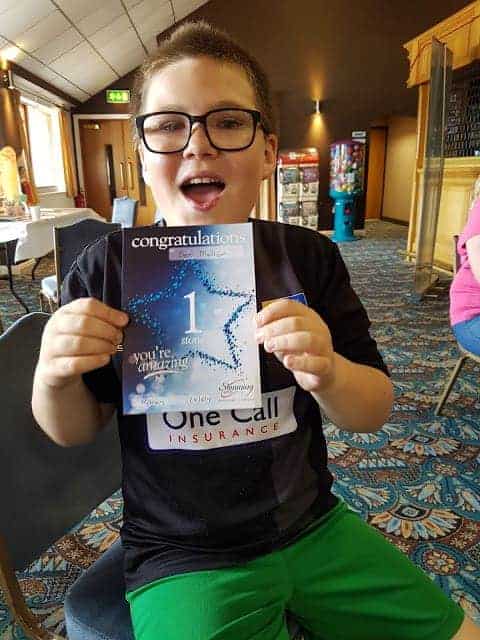 boy holding certificate