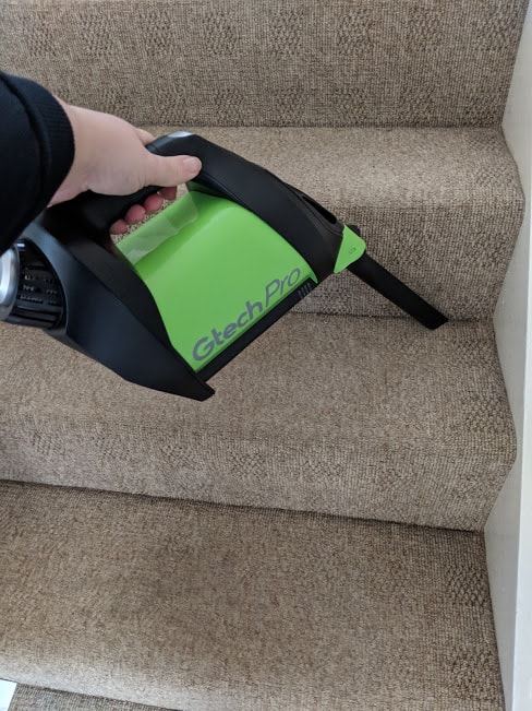 Gtech Pro cleaning the carpet on the stairs