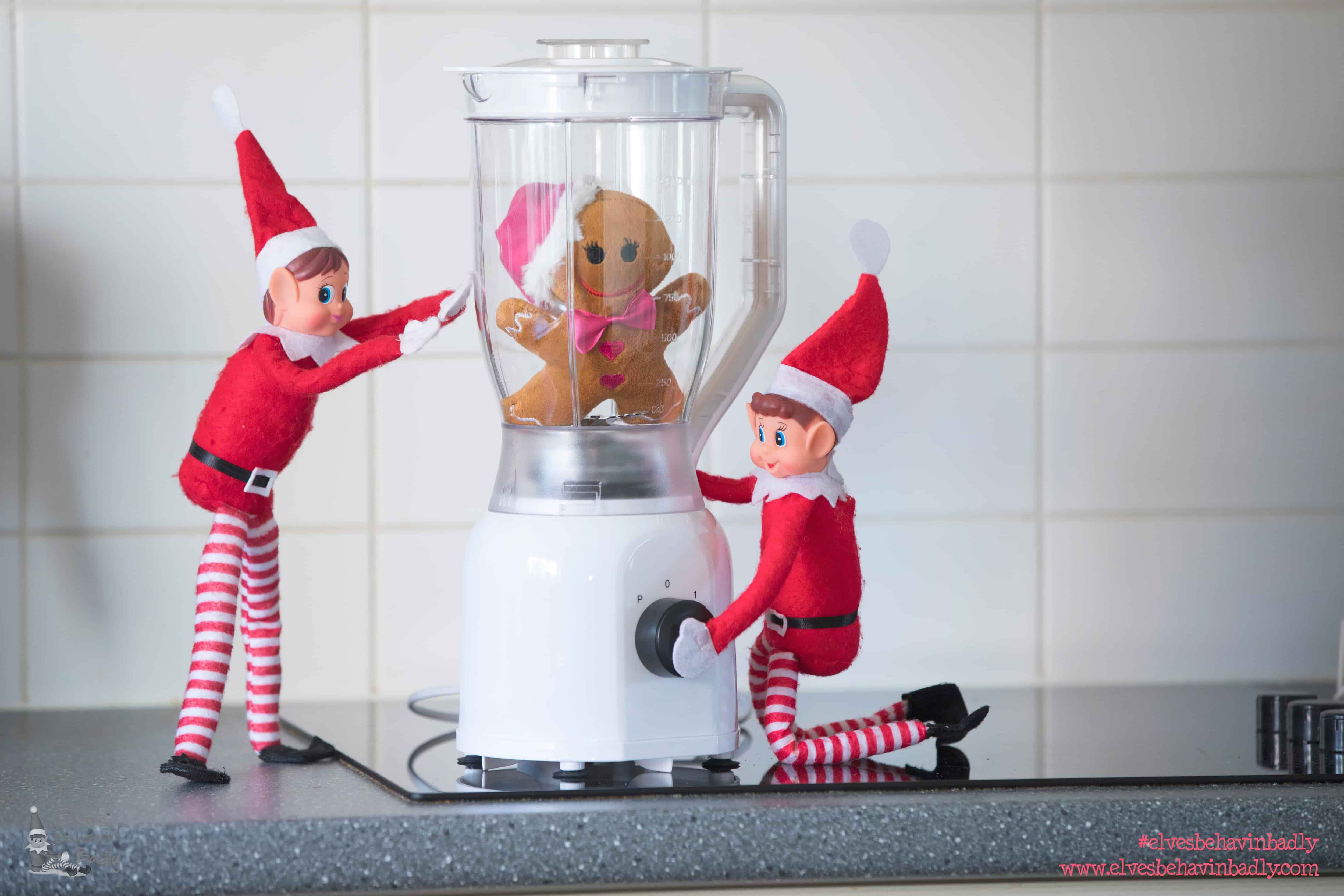 two elves with a gingerbread man in a blender!