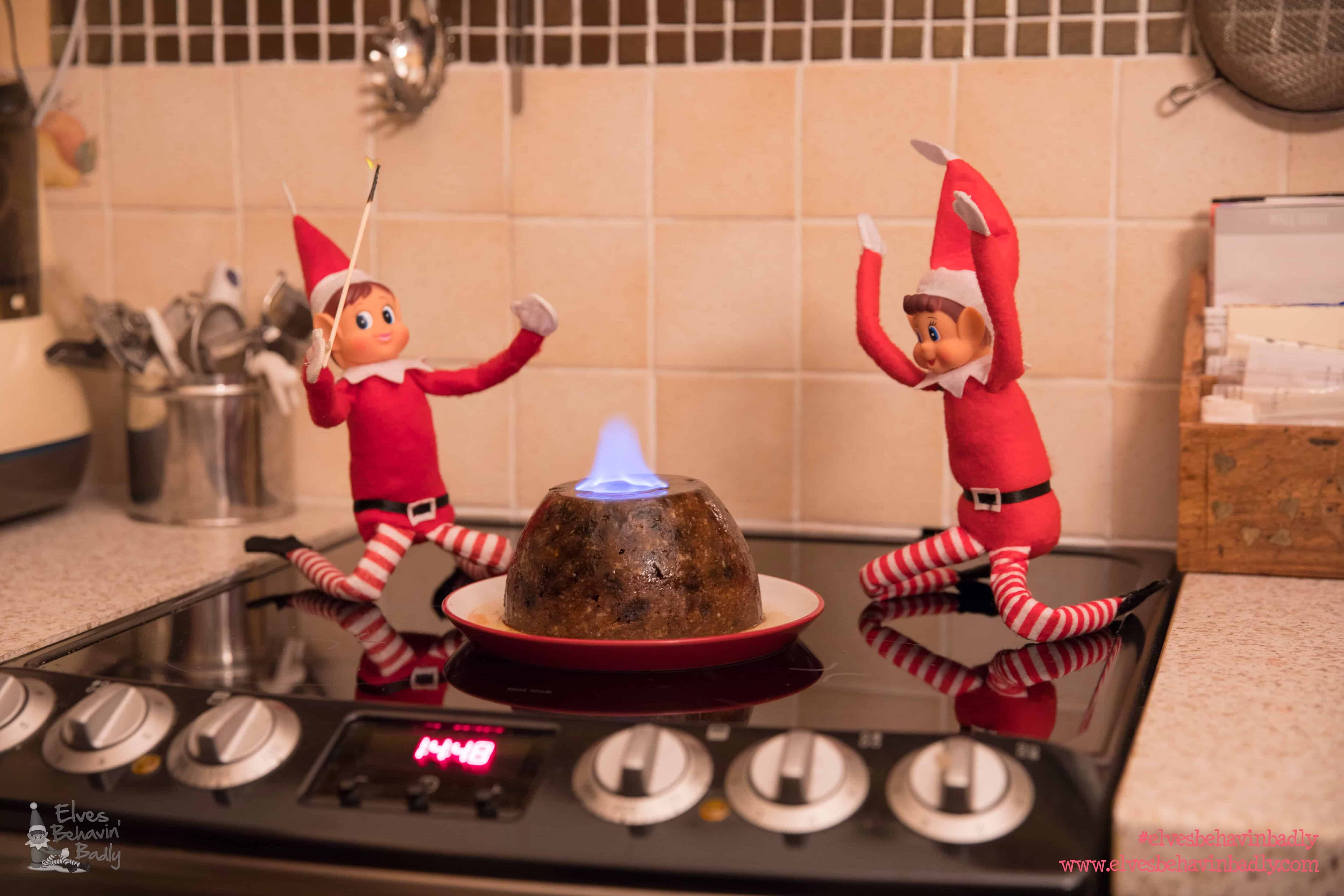 elves with a flaming christmas pudding