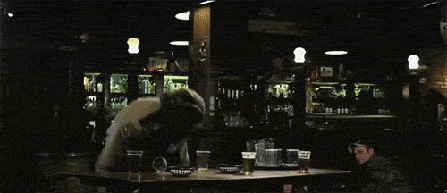 WolfCop smashing a table in a bar during a chaotic scene from the WolfCop movie.