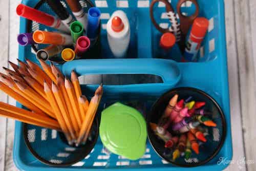 Colored pencil storage ideas: a handled caddy and metal cups make a great mobile coloring supply organizer.