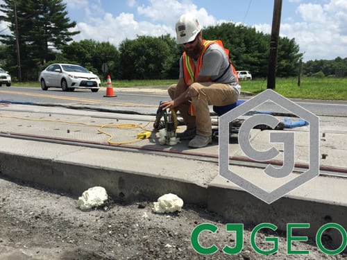 Lifting modular grade crossing using polyurethane grouting.