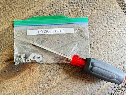 Get organized for a move by placing all screws and hardware for a piece of furniture in a labeled plastic bag. Tape the bag to the underside of the furniture or keep it all in one box.