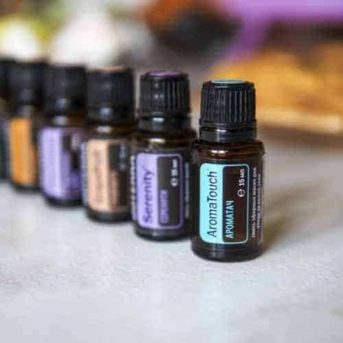 Bottles of essential oils lined up on a counter.