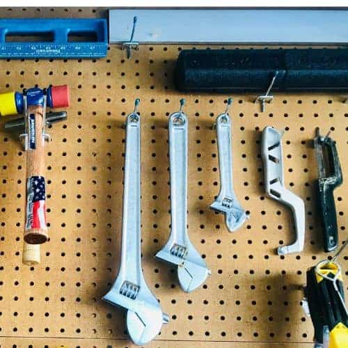 Organize tools on a pegboard: wrenches