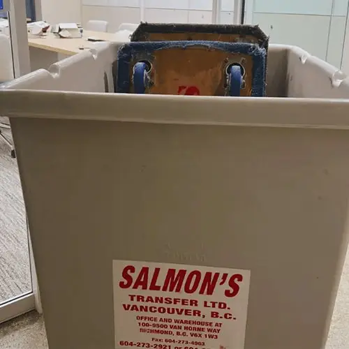 Salmon's Transfer Ltd Vancouver BC moving bin with professional packing services, white plastic moving container with company contact information and office address