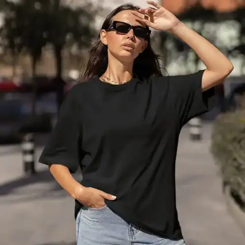 Black premium oversized custom tee lifestyle front view, oversized fit with dropped shoulders and clean print surface