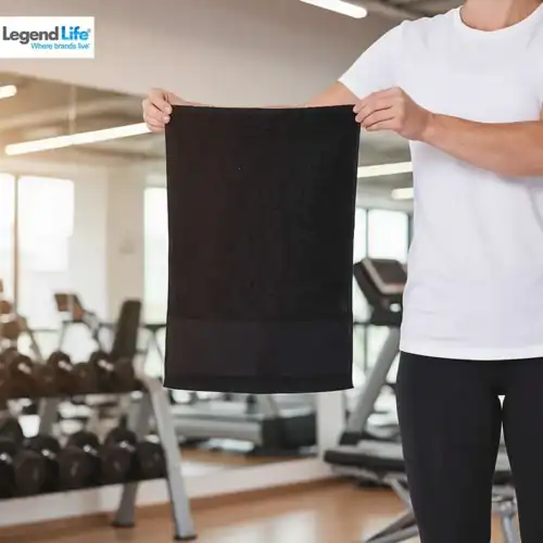 Legend Life Basic Gym Towel in Black with custom print, lifestyle close-up, gym background