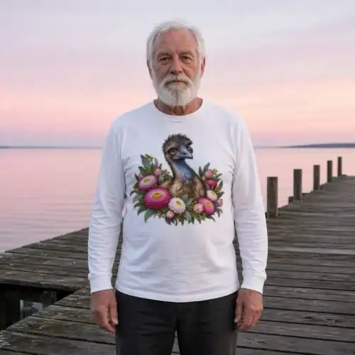 Older man with a white beard on a timber jetty at dawn, wearing the white Elegant Emu with Everlasting Daisies long sleeve T-shirt